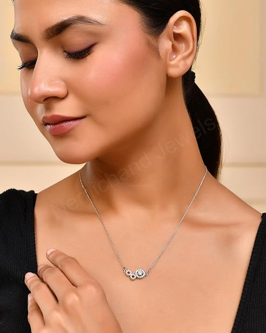 Woman wearing a silver necklace with a delicate pendant on a beige background